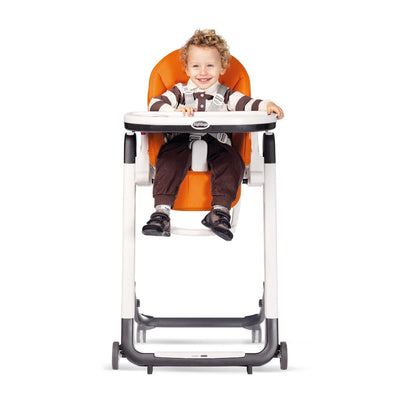 Toddler sitting in the Peg Perego Siesta High Chair in Arancia- Orange