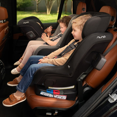 Nuna RAVA Next Convertible Car Seat 3 across in car