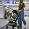 Woman pushing the Peg Perego Volo stroller with a baby inside in an airport