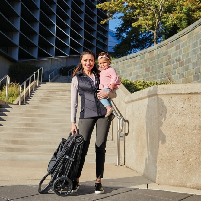 Mom holding baby and the Baby Jogger 2019 City Mini® GT2 Stroller