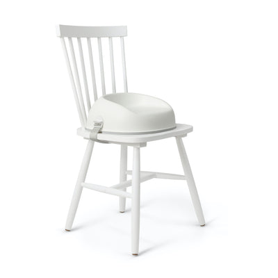 BABYBJÖRN Booster Seat in white attached to chair