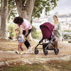 Mom pushing the Maxi-Cosi Tayla Stroller in Essential Red