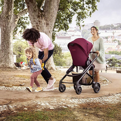 Mom pushing the Maxi-Cosi Tayla Stroller in Essential Red