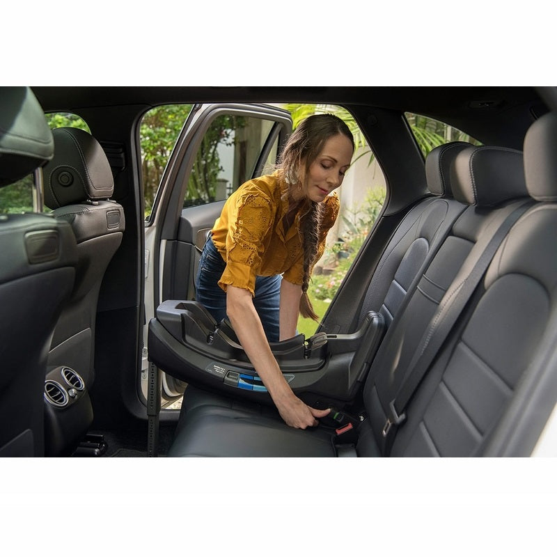 Mom positioning the Nuna PIPA RELX Infant Car Seat Base in the car