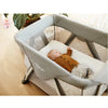 Baby sleeping in the Nuna SENA™ Aire Travel Crib in Granite